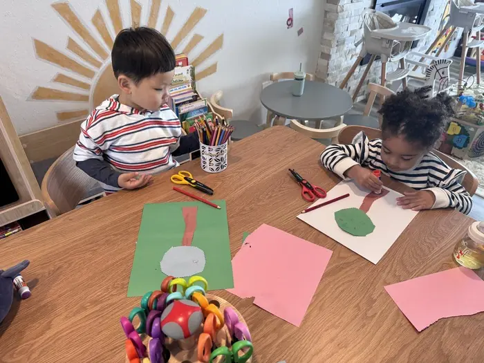 Kids in home daycare in Bothell collaborating on a craft project
