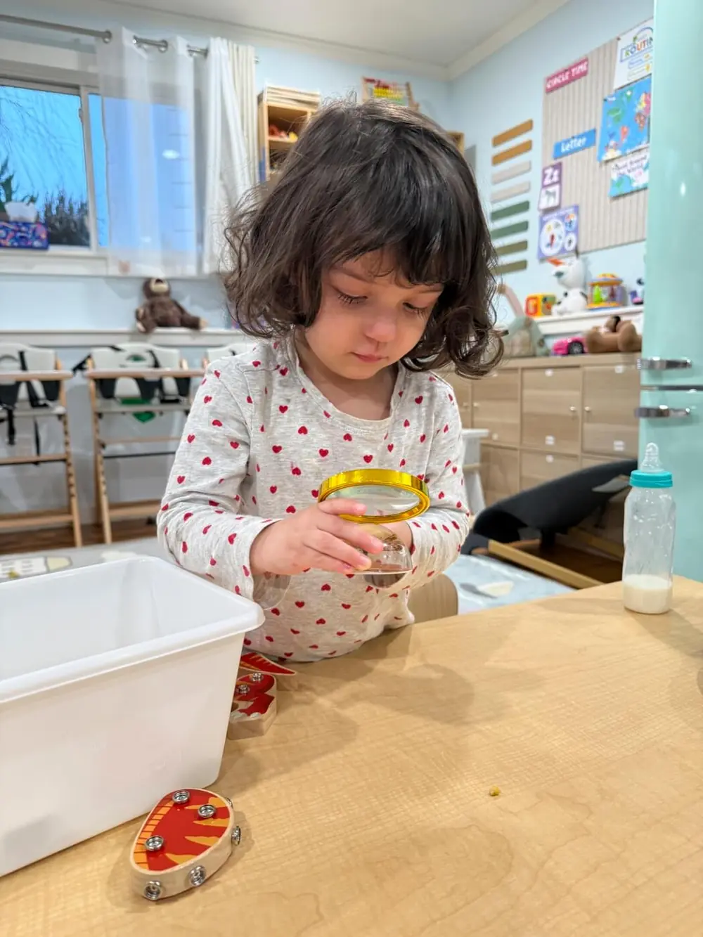 child choosing between toys in daycare
