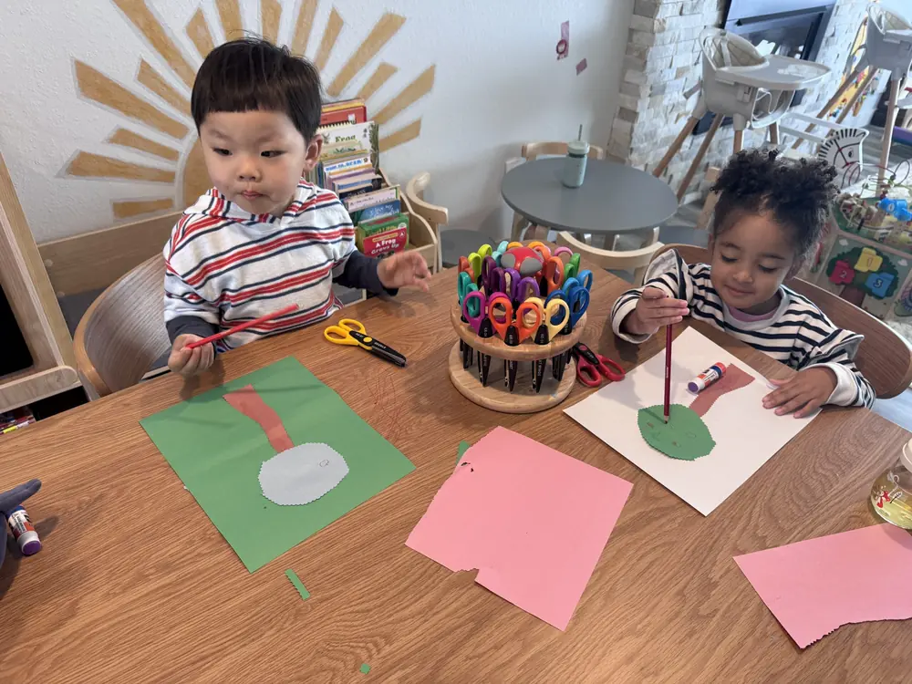 Toddler finger painting with bright colors