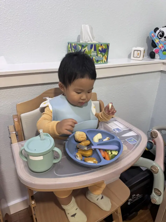 Toddler self-feeding at Kido Heaven
