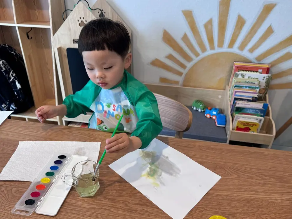 Parent reviewing preschool art in Bothell daycare
