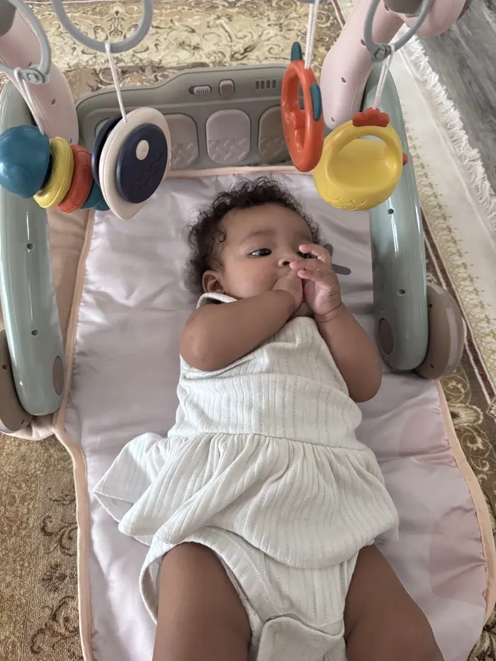 Caregiver assessing a toddler’s milestones with toys.  