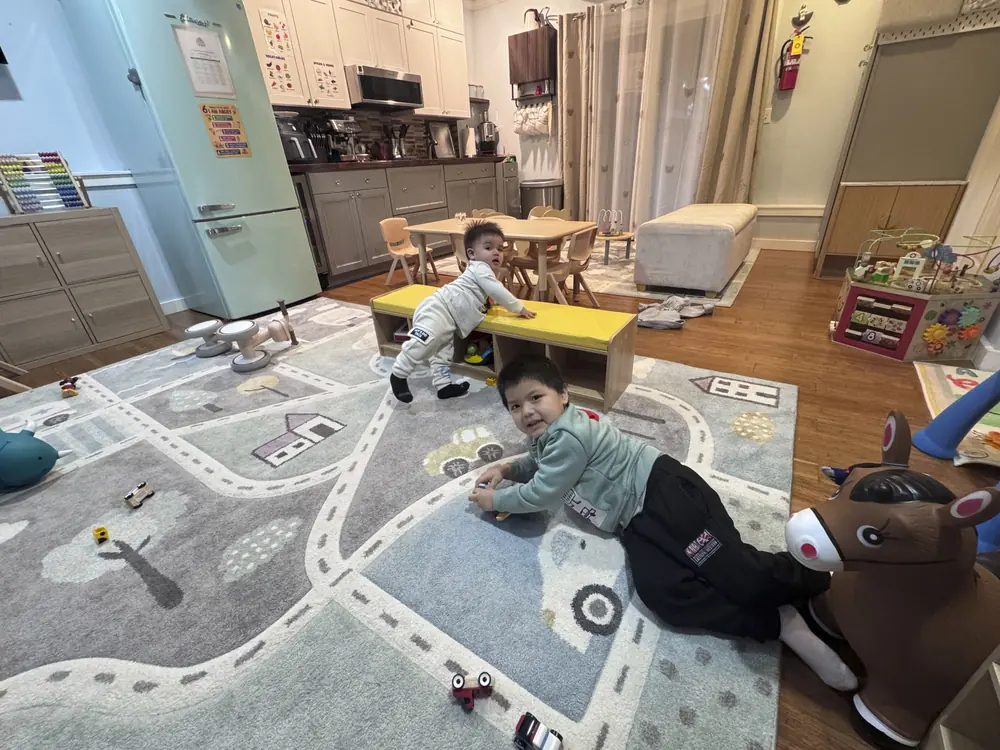 Infant playing with sensory toys in childcare setting
