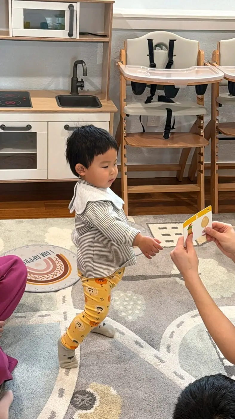 Toddler guided through transition with caregiver support
