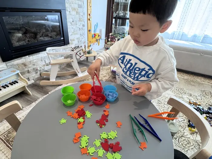  A child in a daycare setting explores colorful, textured toys, promoting sensory development.