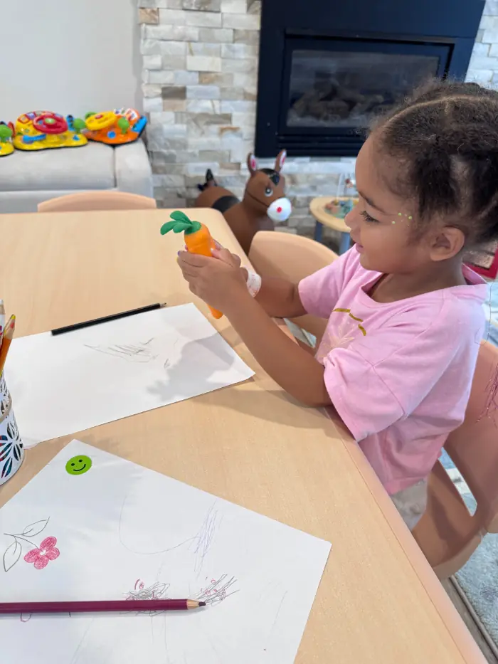 Preschooler encouraged with high-five for positive behavior
